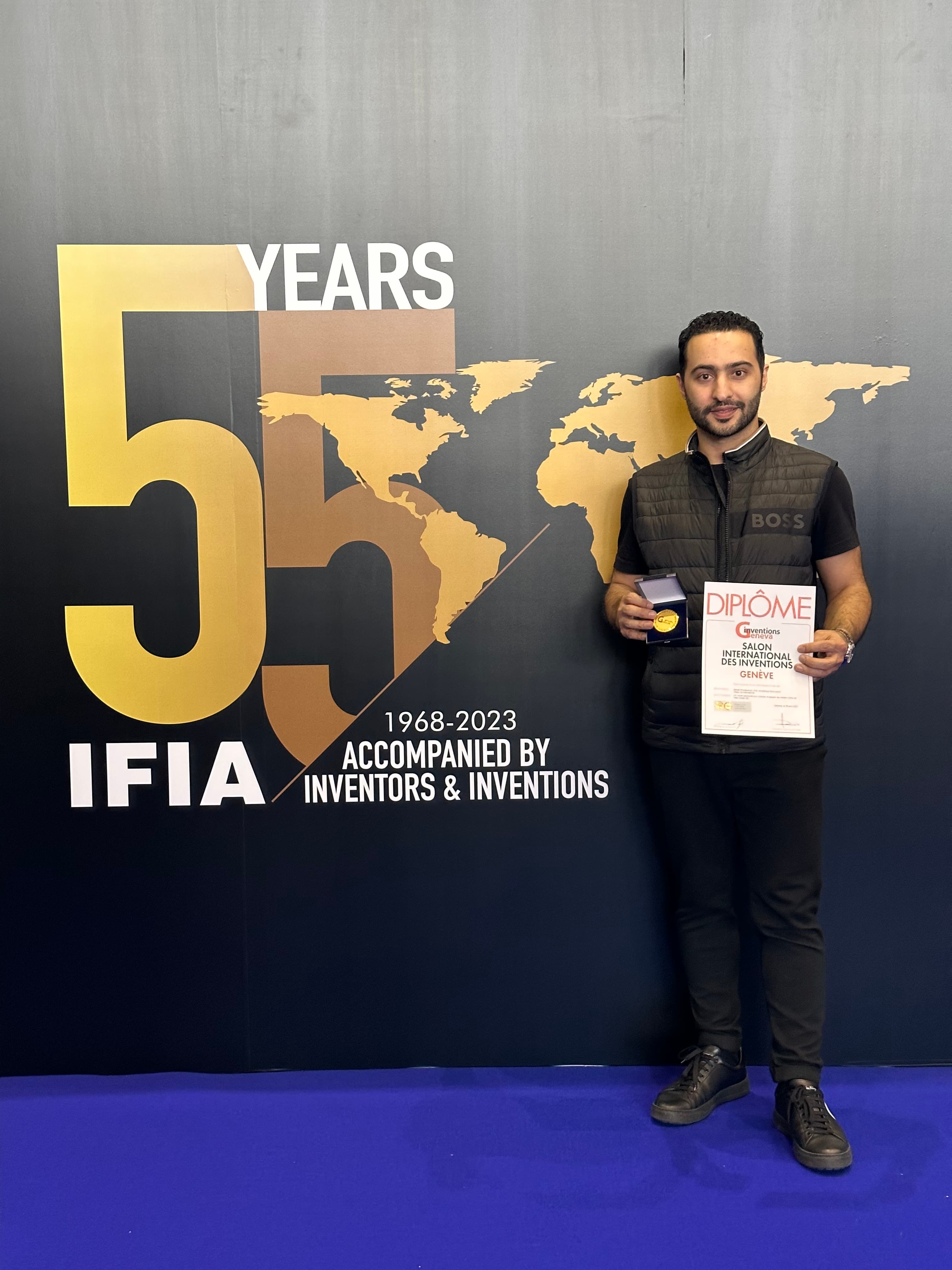 A Canadian inventor holding a gold medal and diploma from the International Exhibition of Inventions in Geneva.